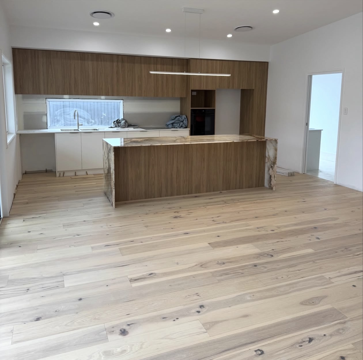Real NPV FLOORS natural oak installation in an open concept Palm Desert kitchen