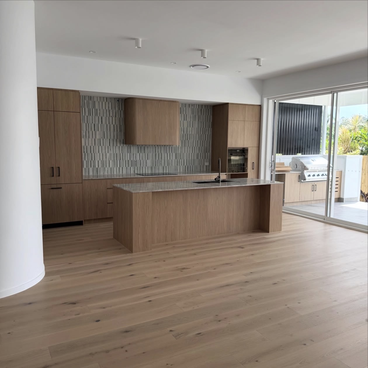 Real NPV FLOORS wide plank oak flooring installation in a Palm Springs kitchen and living area