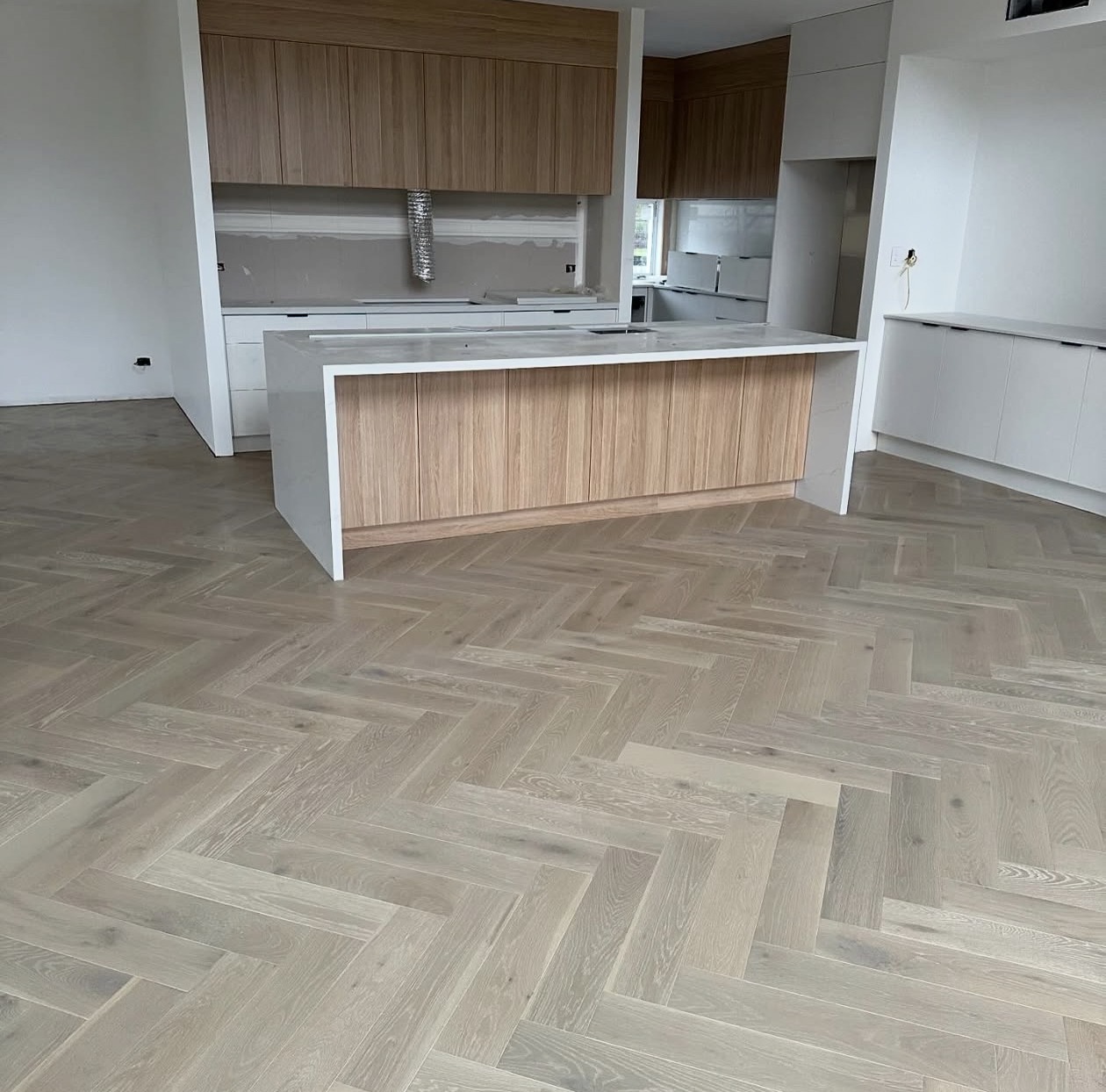 Real NPV FLOORS herringbone oak flooring installation in a Palm Desert kitchen