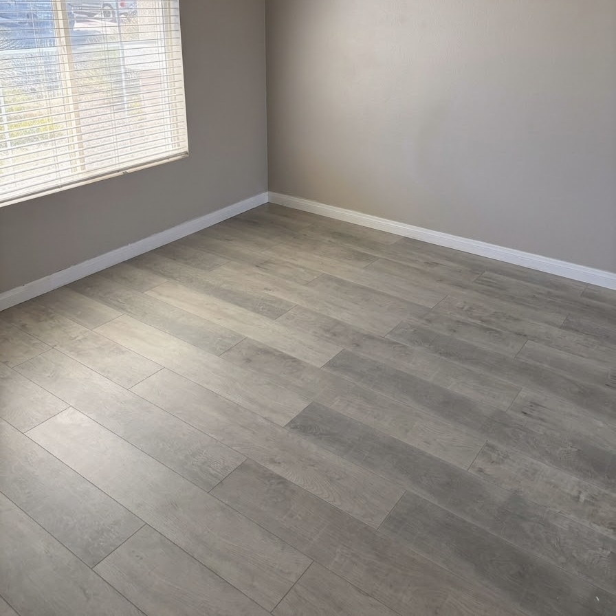 Real NPV FLOORS gray plank flooring installation in a residential room in Indio